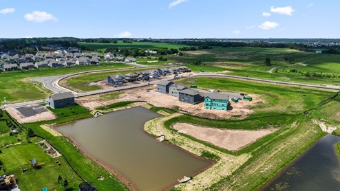 View of stainless steel Whirlpool fridge and double wall oven in kitchen area