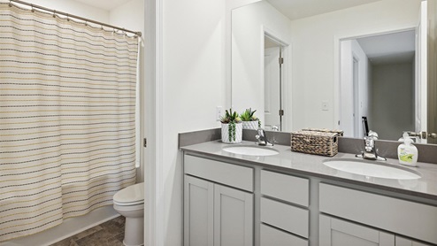 Interior bathroom with full size shower and two sinks