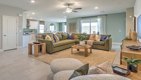 The Symmetry Manor 2538 Plan open concept Great Room with ceramic tile flooring and large windows.