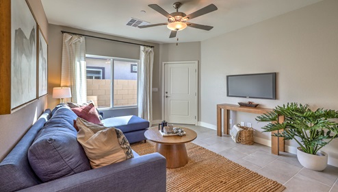 Our Symmetry Manor 2754 Multigen with ceramic tile flooring and a living area with a couch.