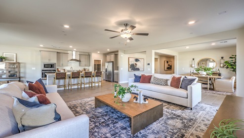 The Symmetry Manor 2754 Plan open concept Great Room with ceramic tile flooring and large windows.