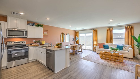 Our 1334 model kitchen in the Spectrum Trails Community with white shaker style cabinets, quartz countertops, a kitchen island, and Whirlpool Stainless Steel appliances.