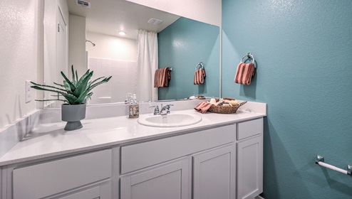 on second floor is a second full sized bathroom with a spacious counter and storage underneath the sink.
