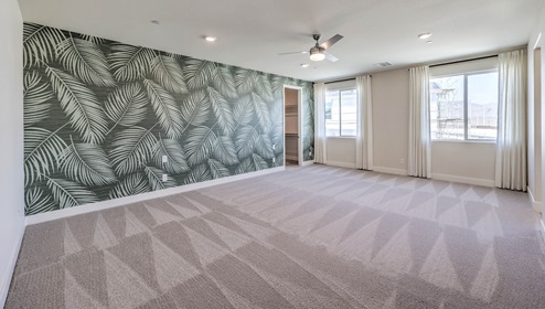 The upstairs loft in our 4425 model with carpet flooring and large windows.