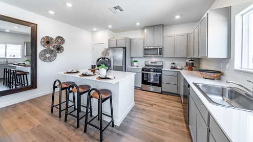Kitchen with island and shaker-style cabinets