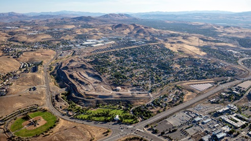 Aerial of Wolfridge community with mountains and park in the background