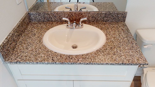 bathroom sink with granite countertops