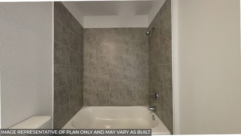bathroom with bath surround tile