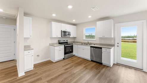 Kitchen with EVP flooring and granite countertops and stainless-steel appliances and hallway and backdoor.