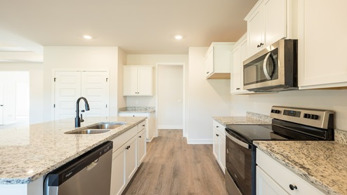 Kitchen with white cabinets and granite counters