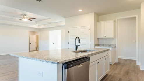 Kitchen with white cabinets and granite counters