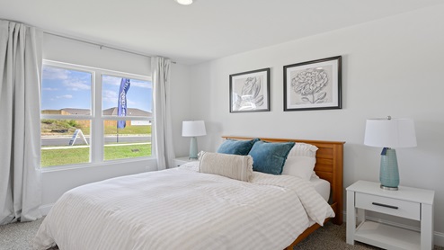 Bedroom four with large window and queen bed