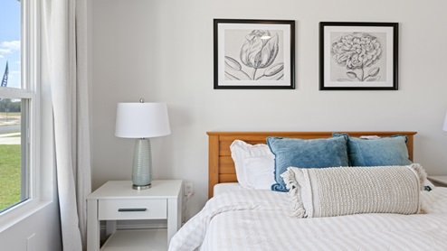 Bedroom four with large window and queen bed