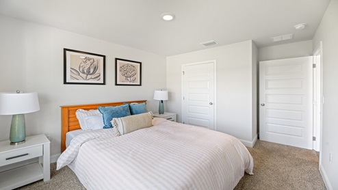 Bedroom four with large window and queen bed