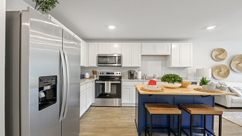 Open kitchen with white cabinets and island