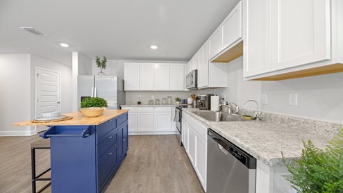 Open kitchen with white cabinets and island