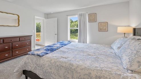 Primary bedroom with queen bed and window