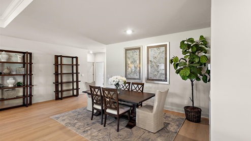 Dining area with hardwood floors and recessed lighting.