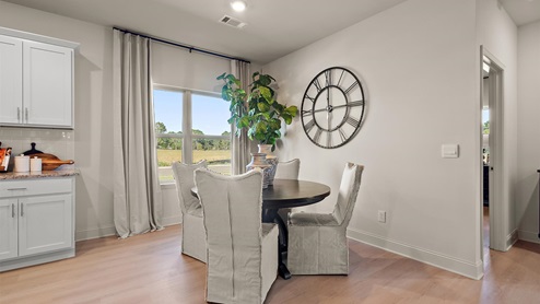 Breakfast nook area with hardwood floors, window, and recessed lighting.