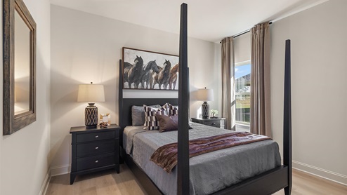 Additional bedroom with window and hardwood floors