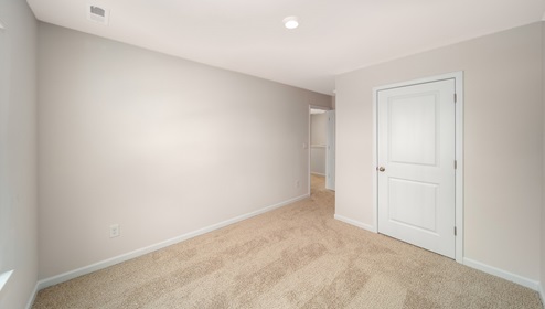 Carpeted bedroom, view of entryway