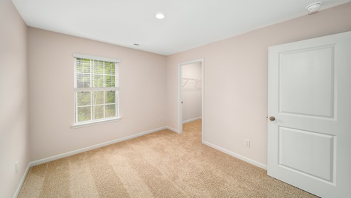 Carpeted bedroom with window