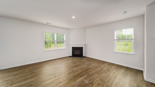 Spacious family room with large windows and fireplace