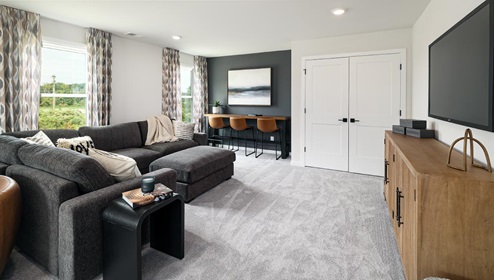 Loft space with carpet and two large windows