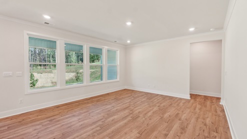 Living room with large windows behind kitchen