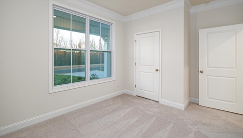 Carpeted bedroom with large window