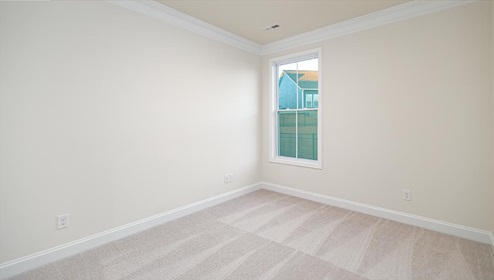 Carpeted bedroom with large window