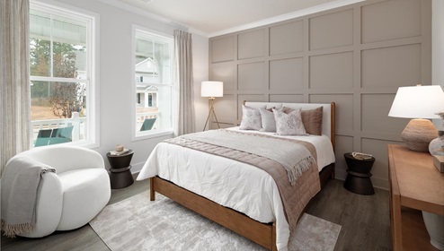 Secondary bedroom with 2 large windows and hardwood flooring