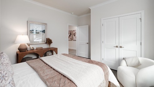 Secondary bedroom with 2 large windows and hardwood flooring