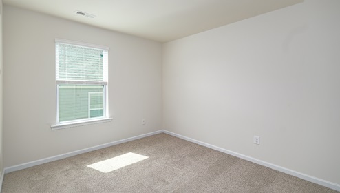 Carpeted bedroom with large window