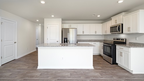 Open kitchen and island with white cabinets