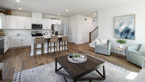 Open concept living room with large windows and fireplace
