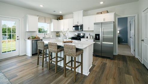 Open kitchen and island with stainless steel appliances