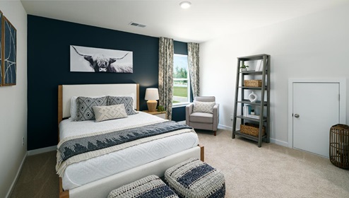 Carpeted bedroom with large windows