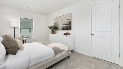 Carpeted bedroom with windows