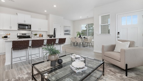 Open concept living room with vinyl flooring and large windows