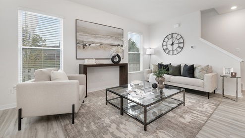 Open concept living room with vinyl flooring and large windows