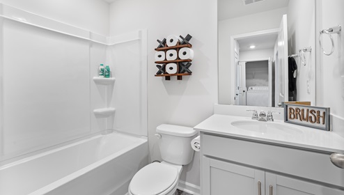 Bathroom with single vanity sink and bathtub.