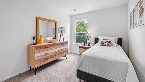 Bedroom with carpet and window.