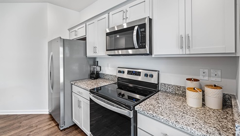 Kitchen and island with stainless steel appliances.