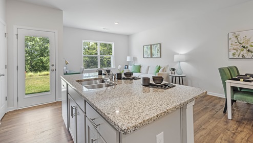 Kitchen and island with view of family room.
