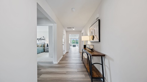 Hallway into home with view of rooms.