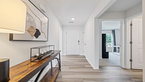 Hallway into home with view of rooms.