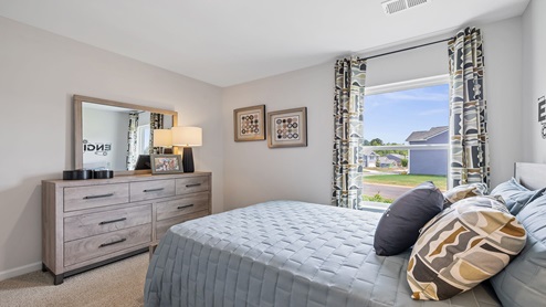 Bedroom with carpet and windows.
