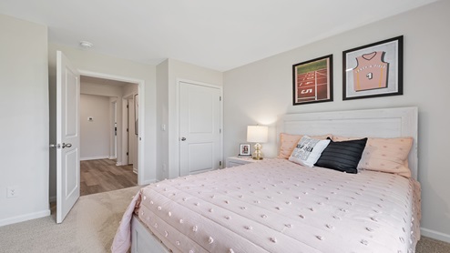Bedroom with carpet and windows.