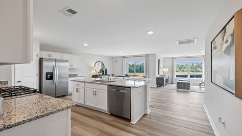 Kitchen and island with granite counter tops.